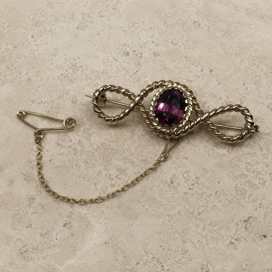 Before — a dated garnet brooch